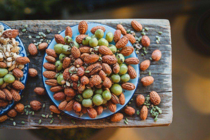 Bowl of mixed roasted nuts and seeds with a golden, spiced coating